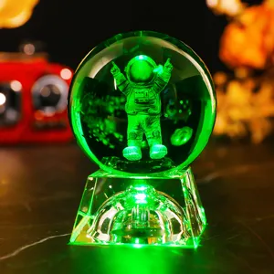 Detail of 3D laser engraved astronaut crystal ball night light with green LED glow