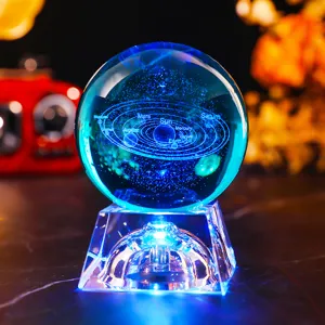 Detailed 3D laser engraved solar system inside a glowing blue crystal ball