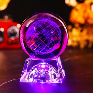 Close-up of 3D laser engraved globe crystal ball night light with purple LED