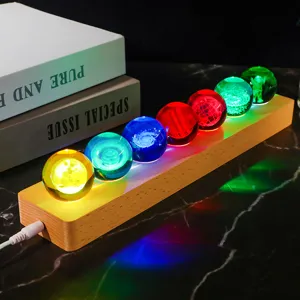 Detailed view of 3D engraved crystal balls on a wooden LED base with galaxy designs