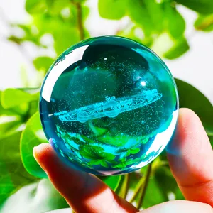 Detailed view of 3D laser-engraved solar system inside a blue crystal ball