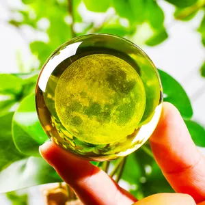 Close-up detail of a 3D laser engraved moon inside a clear crystal ball ornament