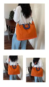 Detail view of large orange travel bag with blue handles shown from three back perspectives