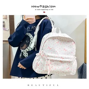 Linda mochila blanca para estudiantes con hermosos lazos rosas y motivos florales de estilo de vida