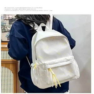 Vista trasera de una persona con mochila blanca de estilo coreano y patrones amarillos