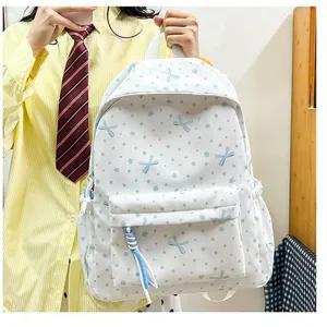 Linda mochila blanca para estudiantes con estampado de lazos azules y flores para viaje