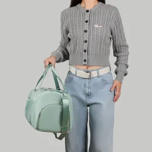 Weibliches Modell mit einer mintgrünen Sporttasche mit großer Kapazität für Reisen
