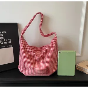 Red and white checkered nylon hobo bag shown with props for size comparison.