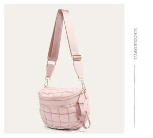 Close-up of pink quilted bubble crossbody bag featuring an adjustable wide strap