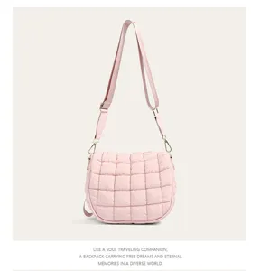 Pink quilted bubble crossbody bag with soft cotton-padded texture and adjustable strap