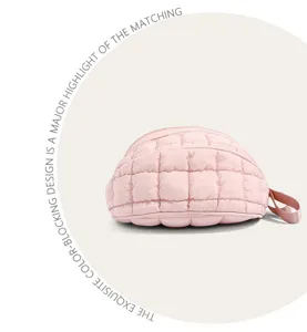 Detailed view of a pink quilted puffy chest bag featuring a soft texture and zipper closure