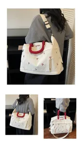 Large stylish white travel bag with red handles and floral embroidery for women gym use