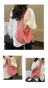 Detailed view of a red and white gingham checkered tote bag styled with a white shirt