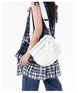 Stylish white quilted puffer crossbody chest bag for women shown on a model side view