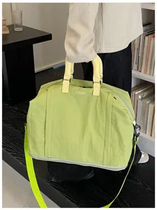Detailed view of lightweight lime green travel gym bag with expandable storage.