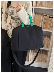 Large capacity black nylon travel bag with green handles and embroidered YIHAO logo.