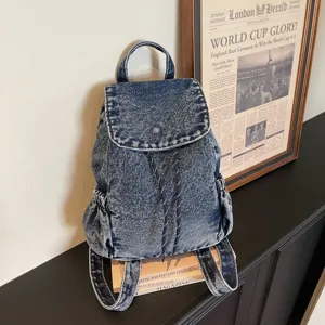 Vintage washed denim backpack featuring a drawstring closure and spacious interior.