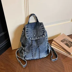 Vintage acid wash blue denim backpack with drawstring and flap closure for students