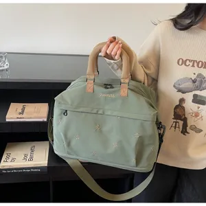 Large capacity green travel bag for women with guomiss embroidery and bow patterns.