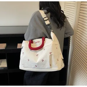 Stylish large white travel duffle bag with red handles and cute embroidery for women