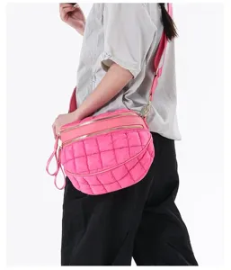 Vibrant pink quilted bubble crossbody bag worn by a model to show style and size details