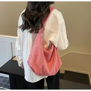 Stylish red and white checkered canvas tote bag shown as a casual shoulder bag detail