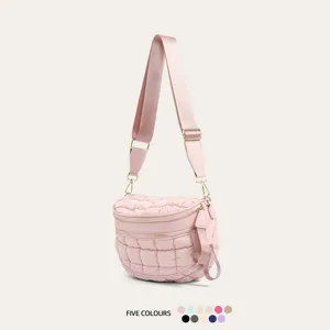 Fashionable pink quilted puffer crossbody bag with adjustable strap and double zipper