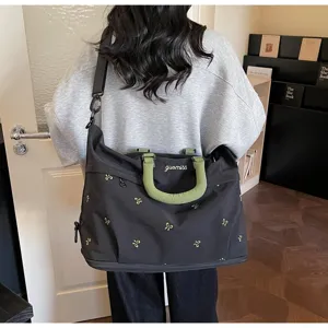 Large black travel gym bag with green handles and bow embroidery details