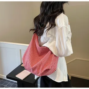 Close-up of a red and white checkered nylon tote bag showing its lightweight fabric texture