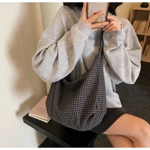 Casual checkered nylon canvas tote bag shown worn by a model in an indoor setting