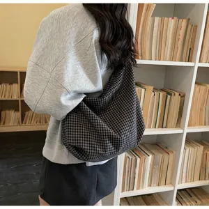 Close-up of a large black and grey checkered nylon tote bag for women's casual wear.