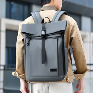 Large capacity gray business casual backpack worn by a man in an urban setting