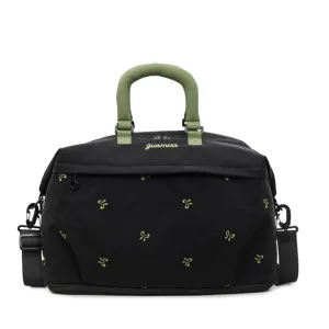 Stylish black canvas travel duffel bag with green handles and embroidered bow patterns