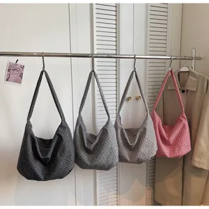 Stylish gingham pattern canvas tote bags in four colors hanging on a display rack