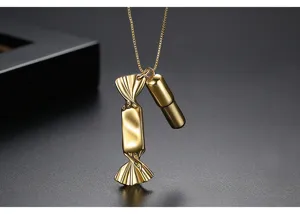 Close-up of creative gold-plated brass candy and capsule shaped pendant necklace
