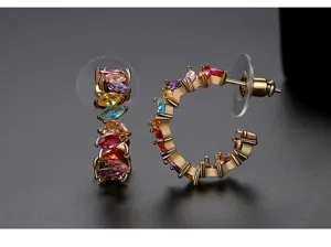 Detailed macro view of gold-plated C-shaped earrings with vibrant multi-color marquise CZ stones