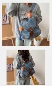 Vintage denim backpack for women, casual retro suede school bag with brown leather trim.