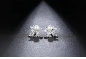 Close-up of elegant freshwater pearl stud earrings with sparkling cubic zirconia clusters