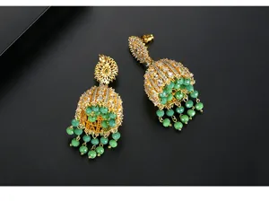 Detail view of ornate Indian style Jhumka earrings with green beads and inlaid zirconia.
