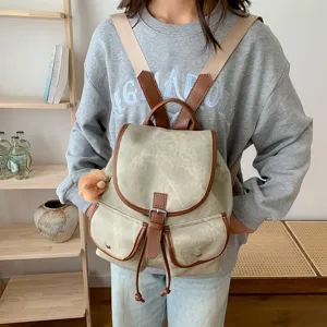 Vintage canvas women backpack casual travel school bookbag with brown leather trim and pockets.