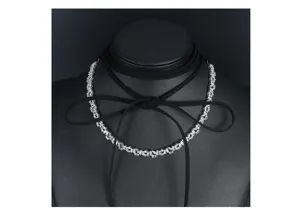 Elegant black ribbon choker necklace with shiny baguette-cut zircon details on a mannequin.