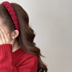 Close-up detail of a red padded heart pattern headband showing the high skull top effect
