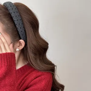 Close-up detail of an elegant grey textured wide headband for a trendy high skull top look