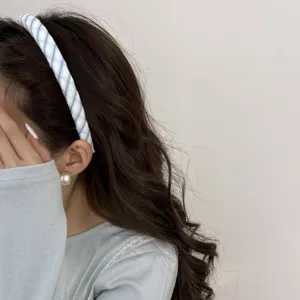 Detailed view of a dreamy blue striped fabric headband on a model for a Korean style.