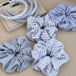 Detailed view of various blue and white striped fabric scrunchies and matching headbands.