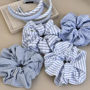 Detail view of dreamy blue striped scrunchies and hairbands for summer hair styling