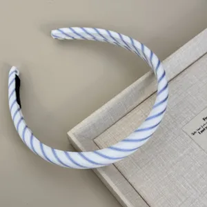 Detailed close-up showing the blue and white striped fabric texture of this elegant headband
