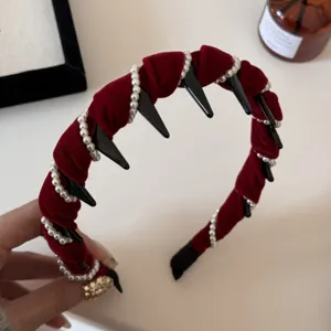 Detailed macro view showing the plush red velvet texture and pearl chains on the headband