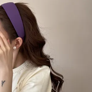 Detailed view of a purple ribbed sponge headband on a model for a chic look