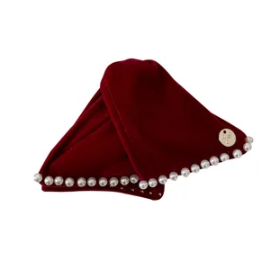 Elegant vintage red velvet headband decorated with white pearls and a golden bow charm